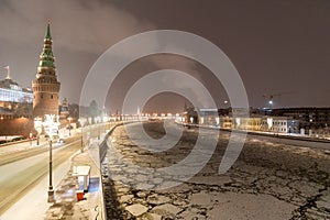 Moscow, Russia - December 27, 2022: Tower of the Moscow Kremlin. Cold and deserted Moscow street on a snowy winter evening near