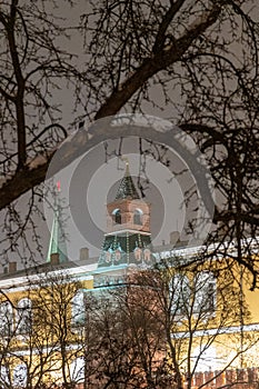 Moscow, Russia - December 27, 2022: Tower of the Moscow Kremlin. Cold and deserted Moscow street on a snowy winter evening near