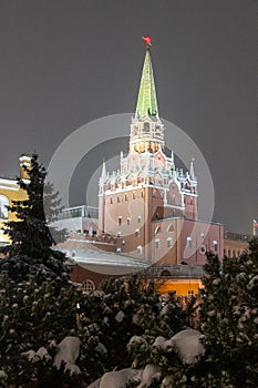 Moscow, Russia - December 27, 2022: Tower of the Moscow Kremlin. Cold and deserted Moscow street on a snowy winter evening near