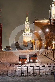 Moscow, Russia - December 27, 2022: Tower of the Moscow Kremlin. Cold and deserted Moscow street on a snowy winter evening near