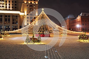 Moscow, Russia - December 7, 2022: Big Christmas tree. New Year decorations and Christmas atmosphere on a winter street in Moscow