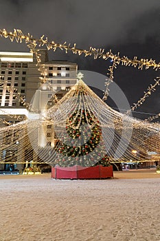 Moscow, Russia - December 7, 2022: Big Christmas tree. New Year decorations and Christmas atmosphere on a winter street in Moscow