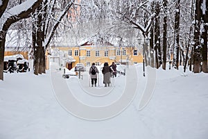Senior women walk along a snow-covered path in the Park