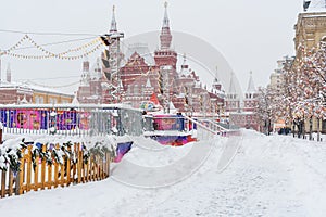 Street with Christmas illuminations decoration on Red Square in snowfall in Moscow. Russia
