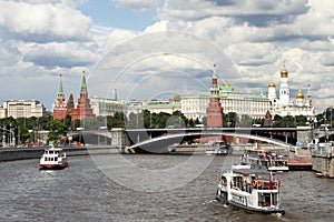 Pleasure boats sails along the river near the Moscow Kremlin.