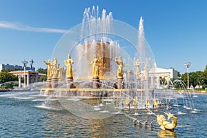 Moscow, Russia - July 22, 2019: View of water surface and golden figures of Friendship of Peoples fountain in VDNH park in Moscow