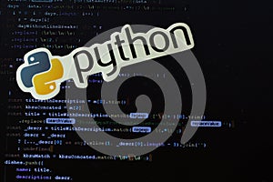 Moscow, Russia - 1 June 2020: Python logo sign with program code on background Illustrative Editorial