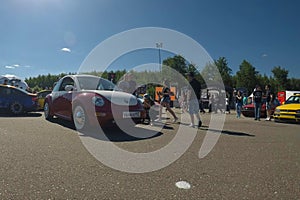 Moscow, Russia - June 01, 2019: Red volkswagen beetle with white elements. lowered car at the parking on th street. Sunny day