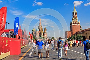 Moscow, Russia - June 28, 2018: Tourists walking near Football Park on Red square on a background of St. Basil`s Cathedral and Mos
