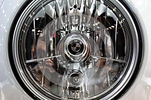 Moscow, Russia - March 17, 2018: A shallow focus shot of the front headlight of a vintage BMW motorcycle.