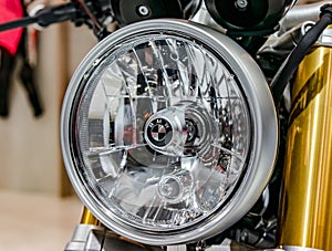 Moscow, Russia - March 17, 2018: A shallow focus shot of the front headlight of a vintage BMW motorcycle.
