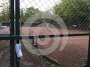 MOSCOW / RUSSIA - May 2020: Quarantined clay tennis court. Refusal of sports as a measure to prevent the spread of the coronavirus