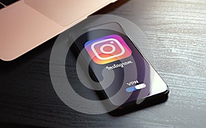 MOSCOW, RUSSIA - MAY 03, 2022: iphone lying on a wooden table, on the screen Instagram social application logo, which