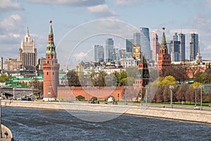 Moscow, Russia - May, 05, 2021: Kremlin Towers and Skyscrapers of Moscow City in spring. The contrast of Moscow architecture with