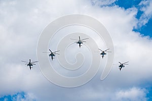 Moscow, Russia - May, 05, 2021: Mi-35M attack helicopters in the sky over Moscow during the parade dedicated to the anniversary of photo