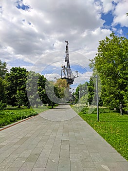 Moscow, Russia - May 31, 2021: Muzeon Art Park. Side view of the statue of Peter Great and the green park area. Vertical