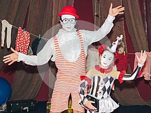 clown man on roller skates with his little assistant girl of his stage persona.