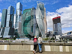 Moscow, Russia - May 31, 2021: View of Moscow city. Girls admire tall skyscrapers and views of the capital