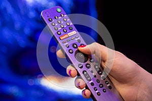 Moscow, Russia - October 04, 2019: female hand holds smart TV remote control with netflix button with microphone and