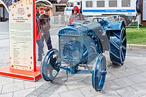 Moscow, Russia - October 08, 2019: Men near restored american wheel tractor FORDSON F on the exhibition of agricultural machinery
