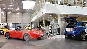 Moscow, Russia - October 05, 2019: Porsche Car Dealership. New Year decorations and preparations. Red 911 convertible stands near