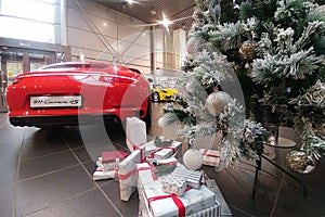 Moscow, Russia - October 05, 2019: The premium car dealership is getting ready for the New Year celebration. Red Porsche 911