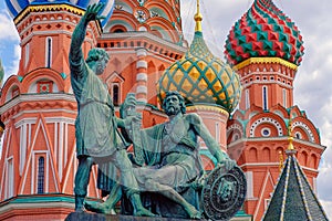 Moscow, Russia. Pozharsky and Minin bronze monument on the Red Square. St. Basils cathedral on background