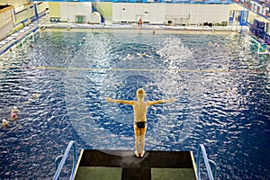Little boy stands on diving-tower in Universal photo