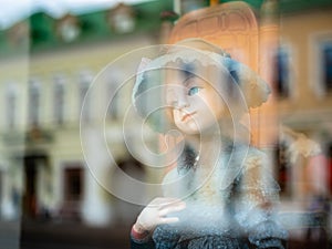 Dolls depicting fairytale heroes in a window of a Moscow Puppet Theater. The figure of a young woman with blue eyes in hat.