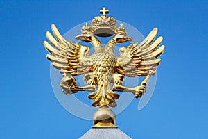 Moscow, Russia - September 13, 2019: Front view of gilded russian double-headed eagle on a blue sky background at sunny day