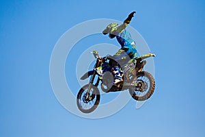 Moscow / Russia - September 23 2017: Pro motocross rider riding fmx motorbike, jumping performing extreme stunt. Professional