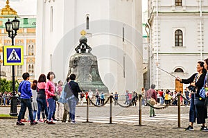 MOSCOW, RUSSIA - 06 14 2016: Tourists in Moscow Kremlin crossing the road towards the Tsar Bell, a masterpiece of