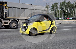 MOSCOW, RUSSIA - 29.05.2015. Yellow Smart Car with advertising Line-x on Moscow Ring Road