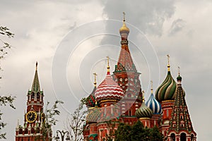 Moscow`s kremlin. View of the Spasskaya tower and St. Basil`s Cathedral