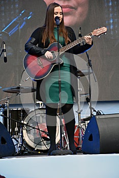 Moscow Transport Day-2019. Singer woman on stage plays guitaar