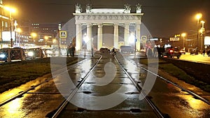 Moscow Triumphal gate at night Street with trams.