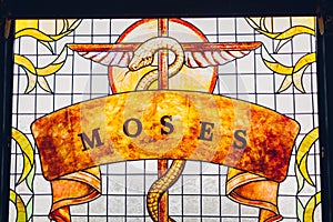 Moses painting on stained glass window. Brazen serpent on stick