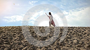 Moses with staff hardly walking in sands, exhausted ascetic fasting to save soul photo