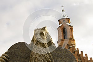 Moses statue and a belfry of a gothic church in a background