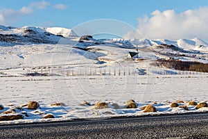 Mosfellskirkja, a small church in the snowy mountains in Iceland photo