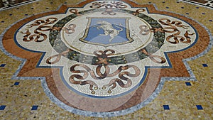 Mosiac of the Bull of Turin in the center of the Galleria Vittorio Emanuele II in Milan, Italy`s oldest shopping mall.