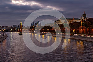 Moskva river and Moscow Kremlin on a background of dramatic cloudy sky in evening