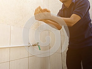 A moslem man take ablution before praying.