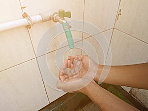 A moslem man take ablution before praying.