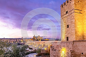 Mosque-Cathedral and the Roman Bridge with Callahora Tower Torre de la Calahorra at sunset in Cordoba, Andalusia, Spain