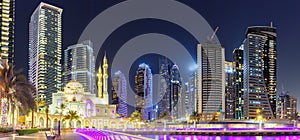 Mosque at Dubai Marina skyline architecture wealth luxury travel at night panorama in United Arab Emirates