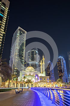 Mosque at Dubai Marina skyline architecture wealth luxury travel at night portrait format in United Arab Emirates