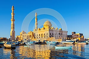 Mosque with fishing boats at sea in egypt