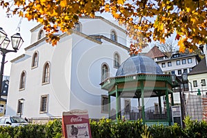 Mosque with fountain in front, with large glass building. High quality photo