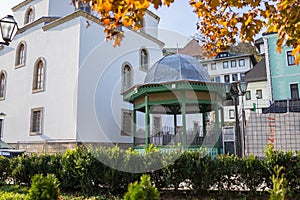 Mosque with fountain in front, with large glass building. High quality photo